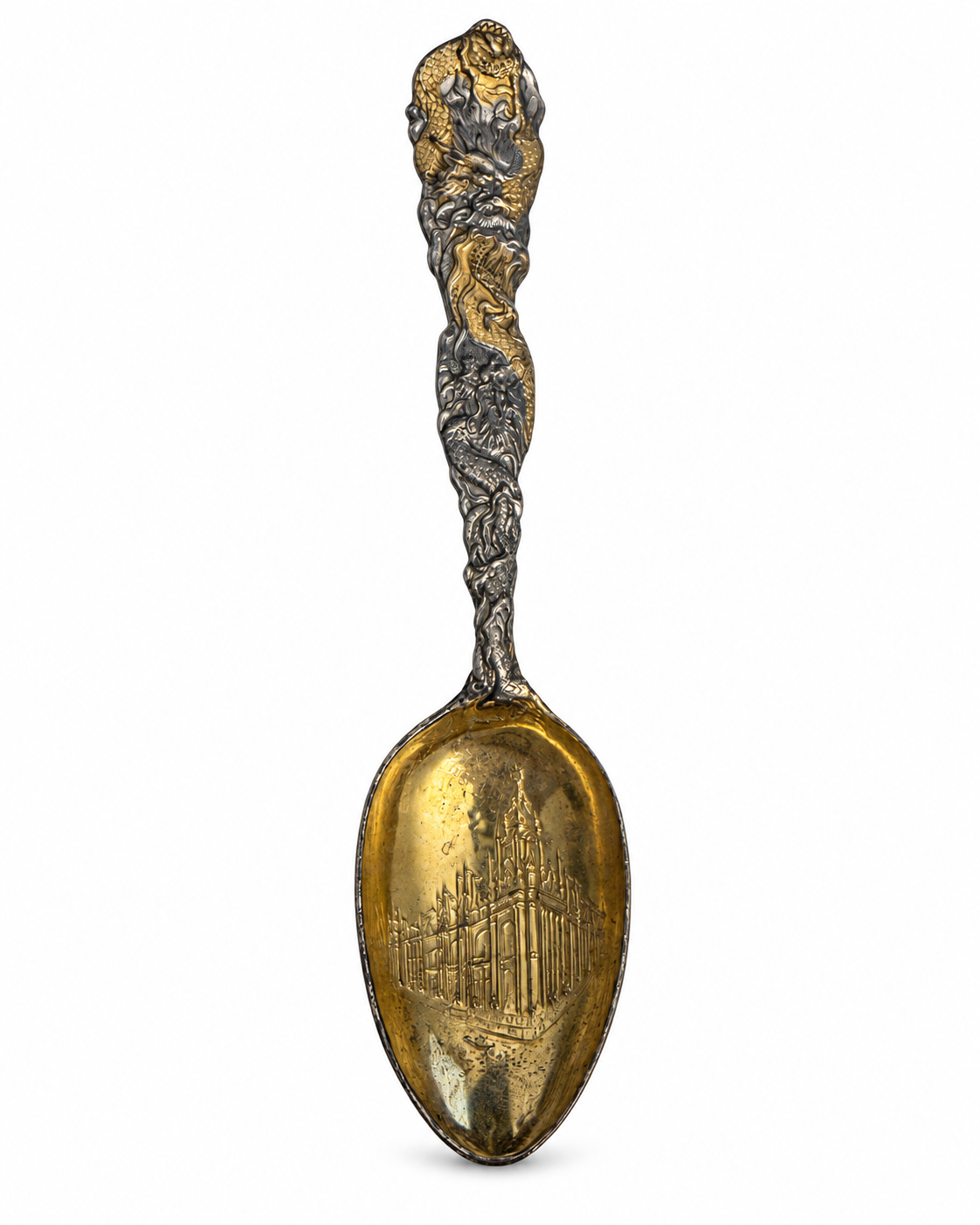 Close-up of the souvenir spoon’s decorative dragon handle and aged silver-tone finish.