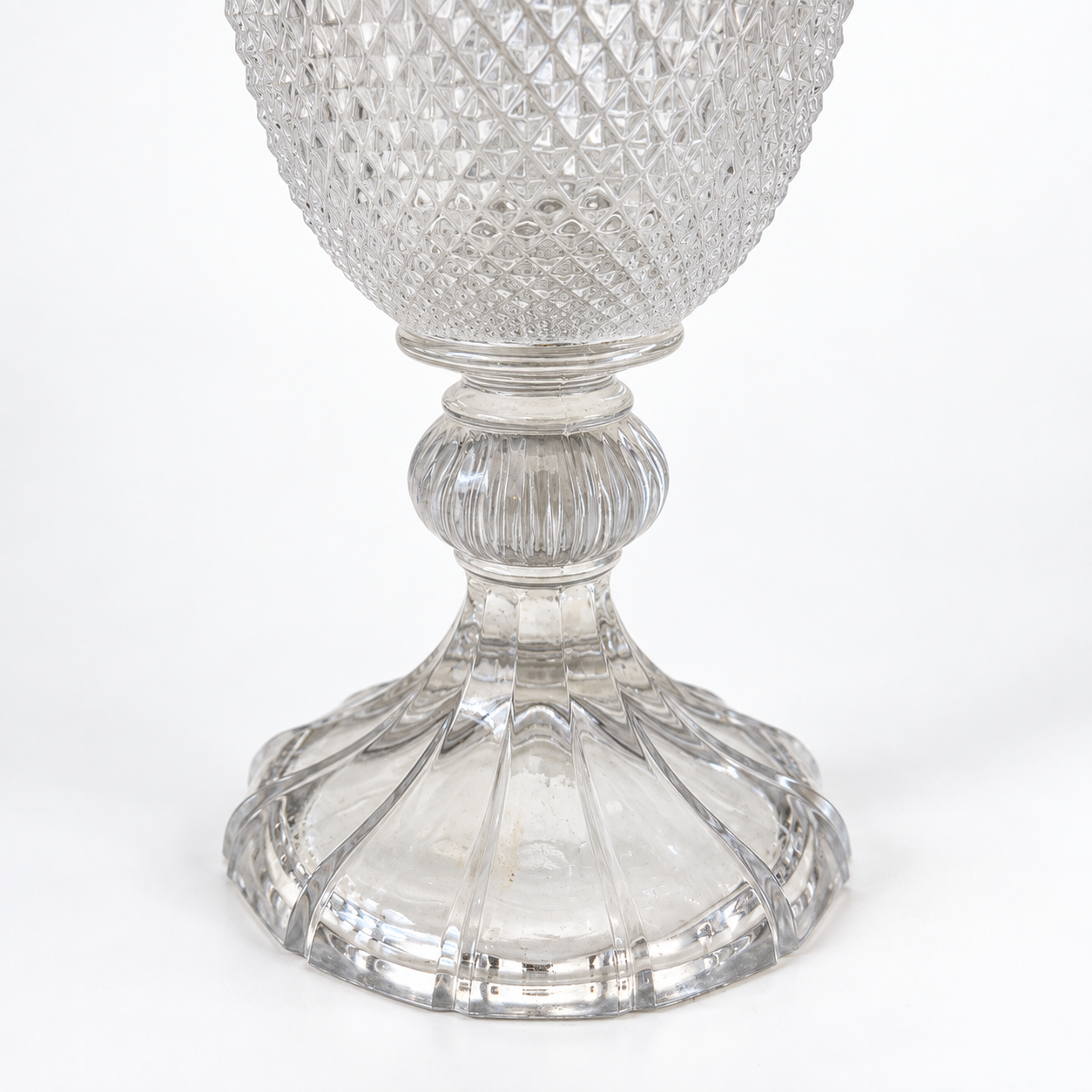 Detail of the vase’s ribbed stem and round fluted pedestal foot.