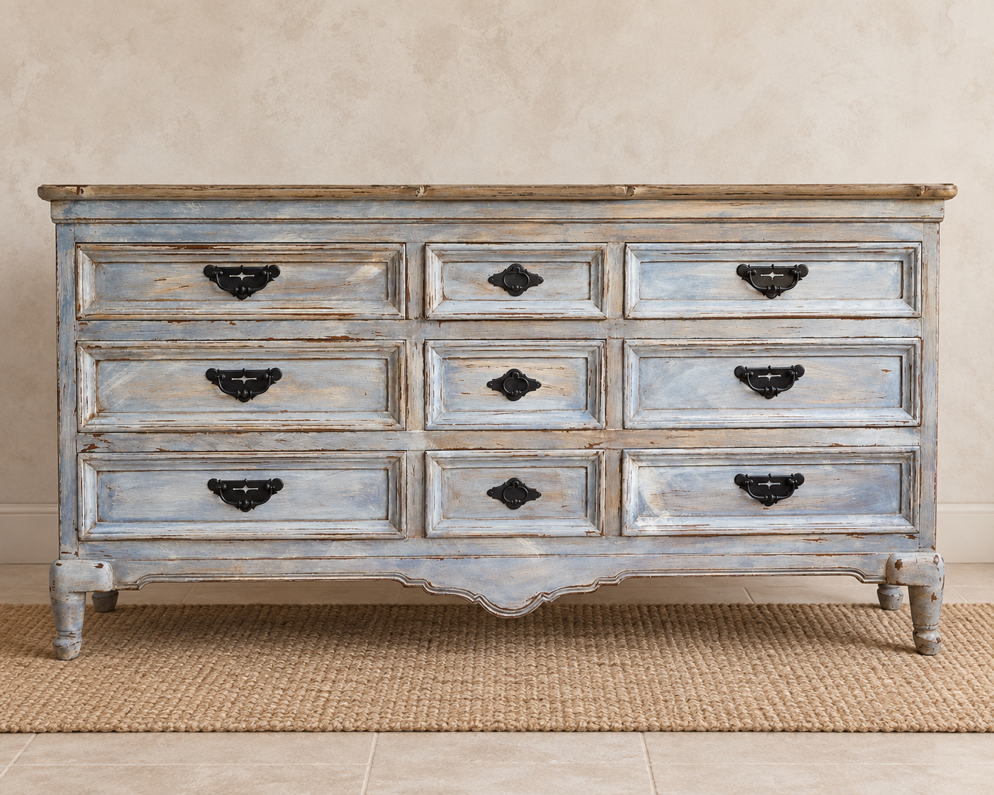 DNine-drawer vintage dresser refinished in layered pale blue, gray and cream with dark metal hardware and a scalloped apron