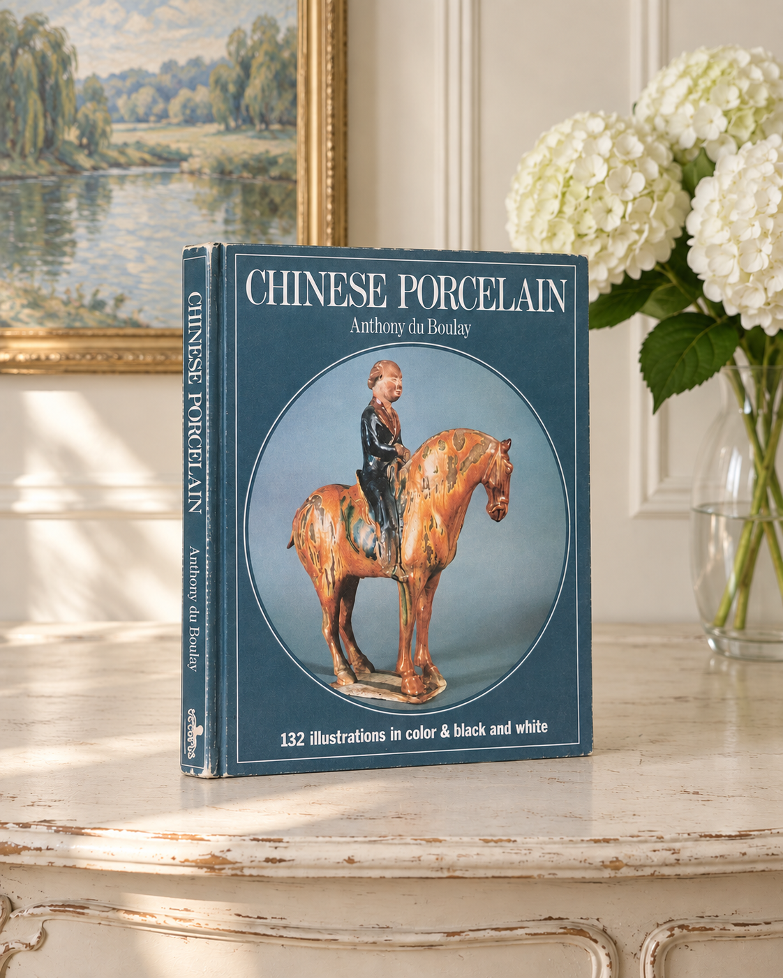 Vintage Chinese Porcelain book with its cover and spine visible in a softly lit French interior.