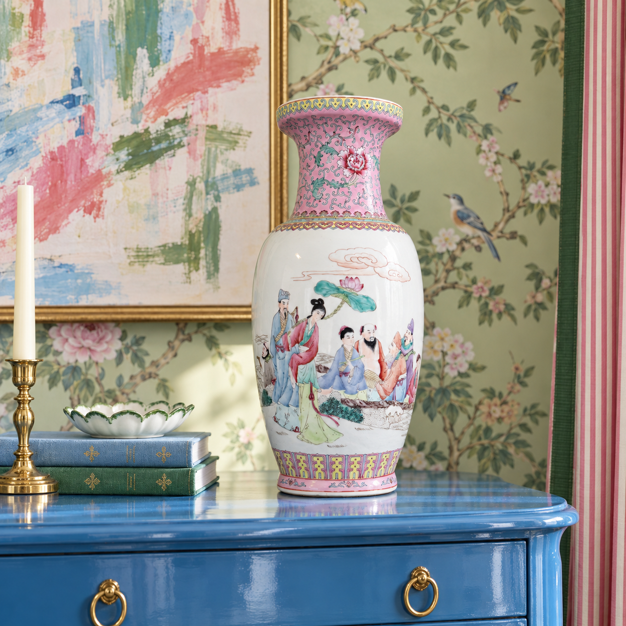 Pink figural vase on a blue lacquer chest against green chinoiserie wallpaper.