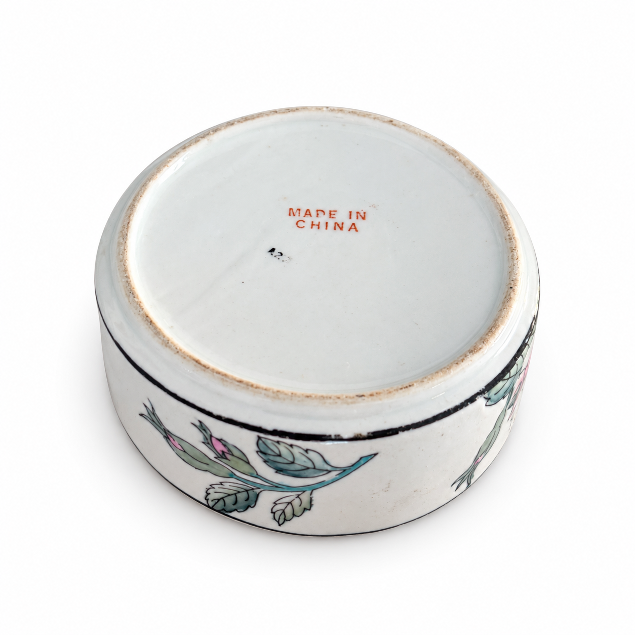 underside  Underside of the floral porcelain box showing its red Made in China mark and worn foot rim.