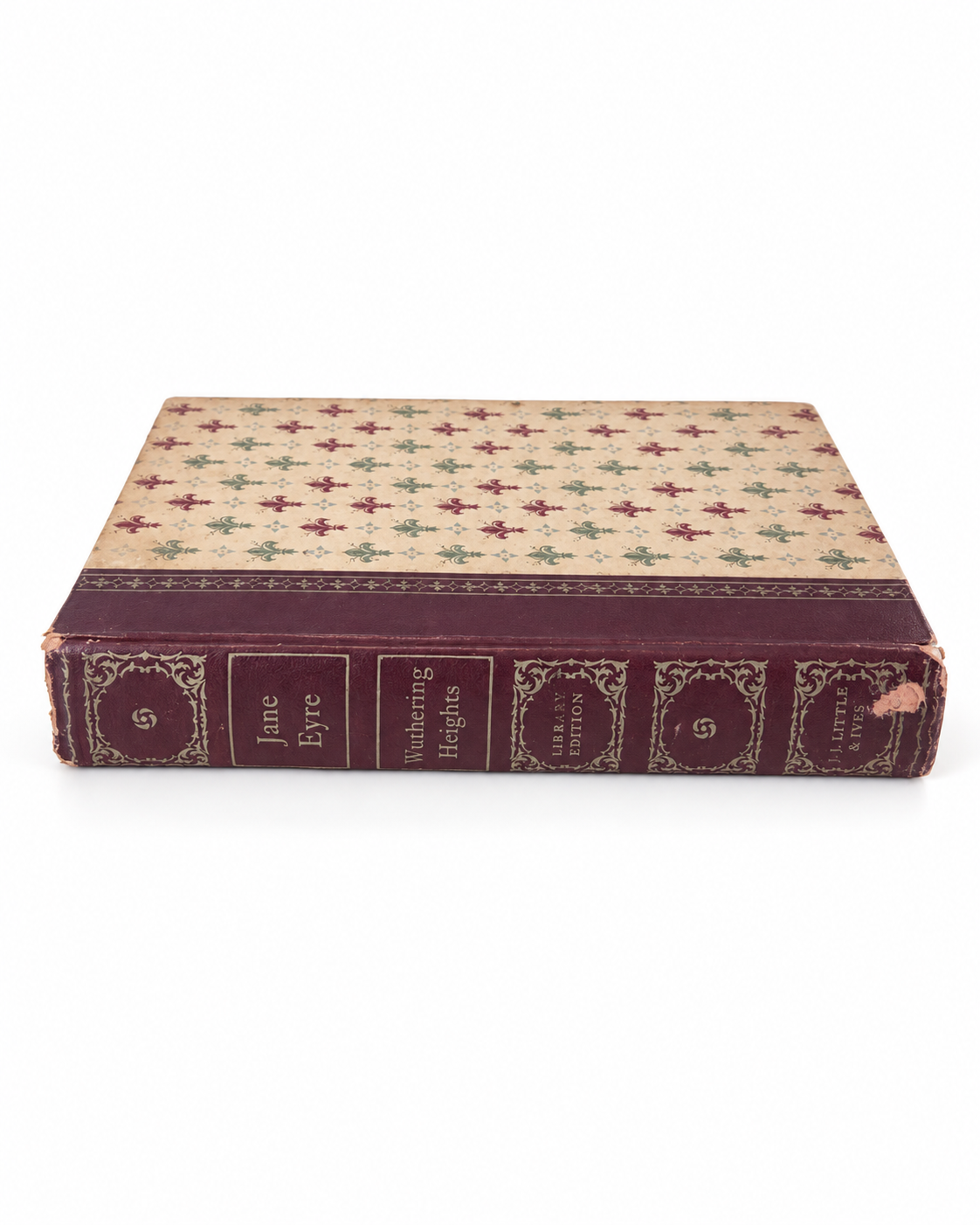 Vintage Brontë book with cream fleur-de-lis front cover and burgundy binding.