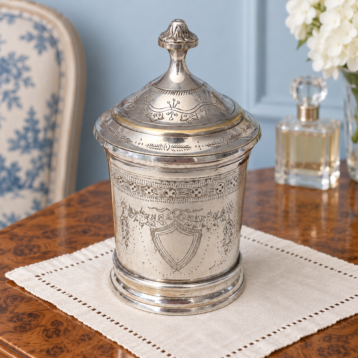 Close view of the engraved decoration and finial on the jar's domed lid.