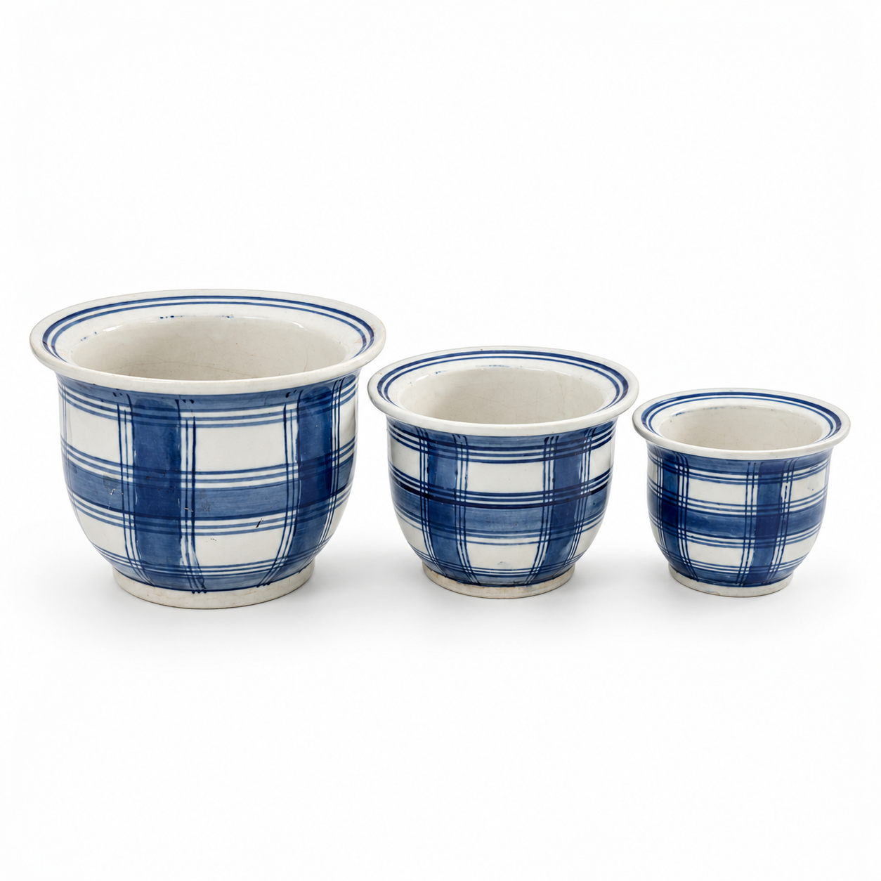 Elevated view of three plaid planters showing their open interiors and striped rims.