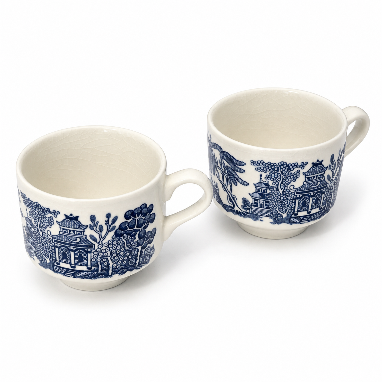 Elevated view of two Blue Willow cups showing their cream interiors and rounded openings.
