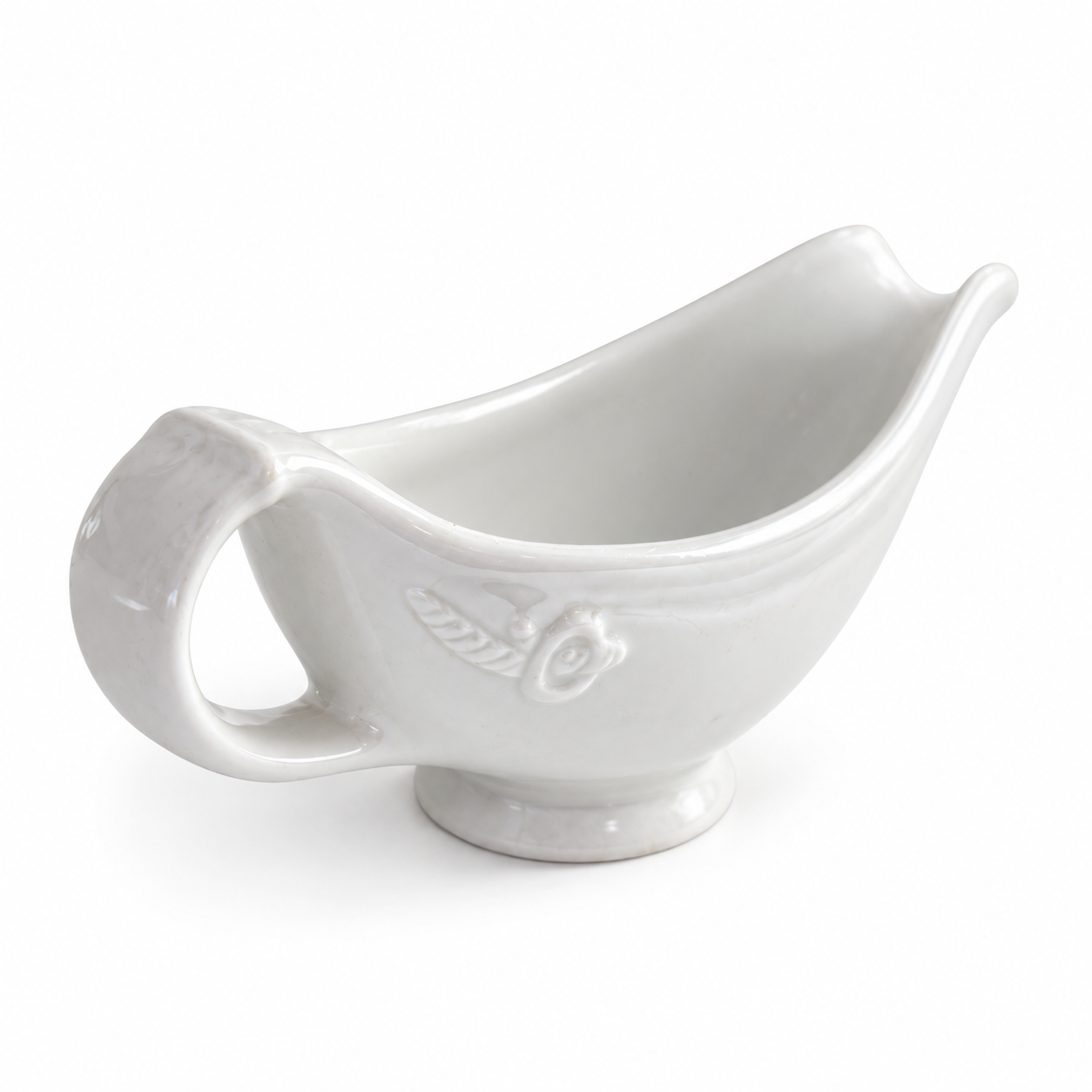 Elevated view of the white Hall gravy boat showing its open bowl, sweeping spout and loop handle.