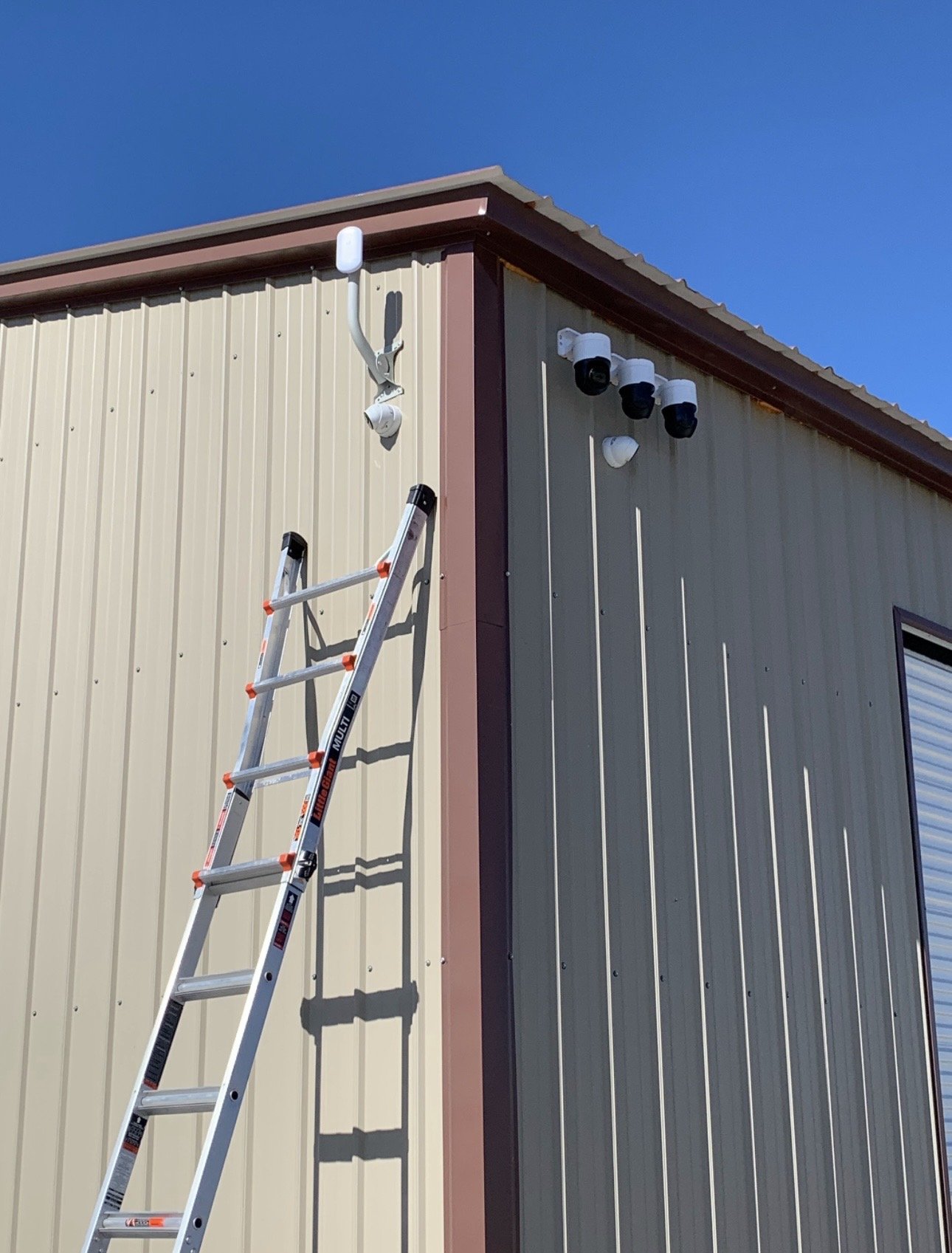 PTZ security cameras and wireless network bridge installed on a commercial building in Norman, Oklahoma
