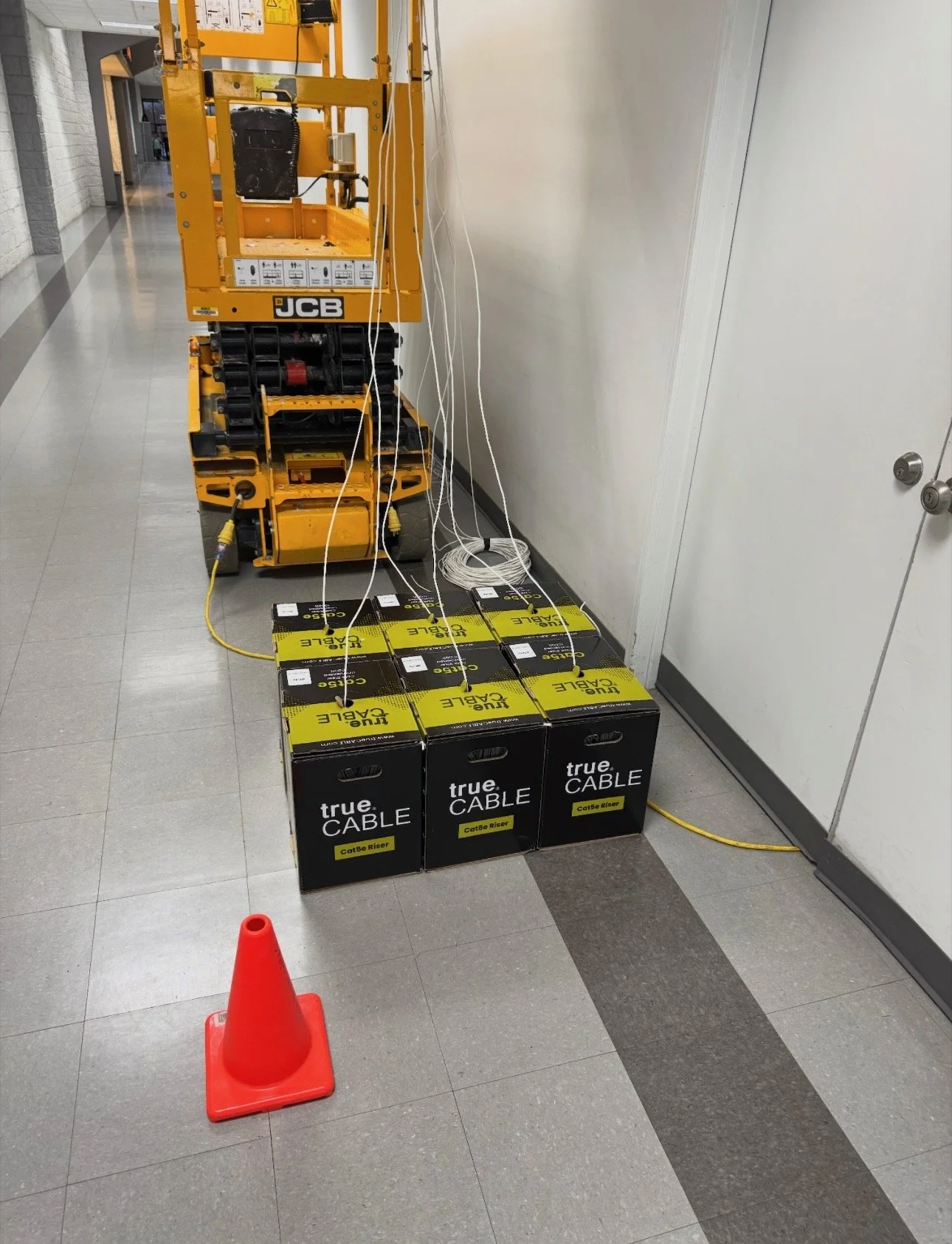 SecureWirx network cabling installation with scissor lift and cable boxes in Norman, Oklahoma