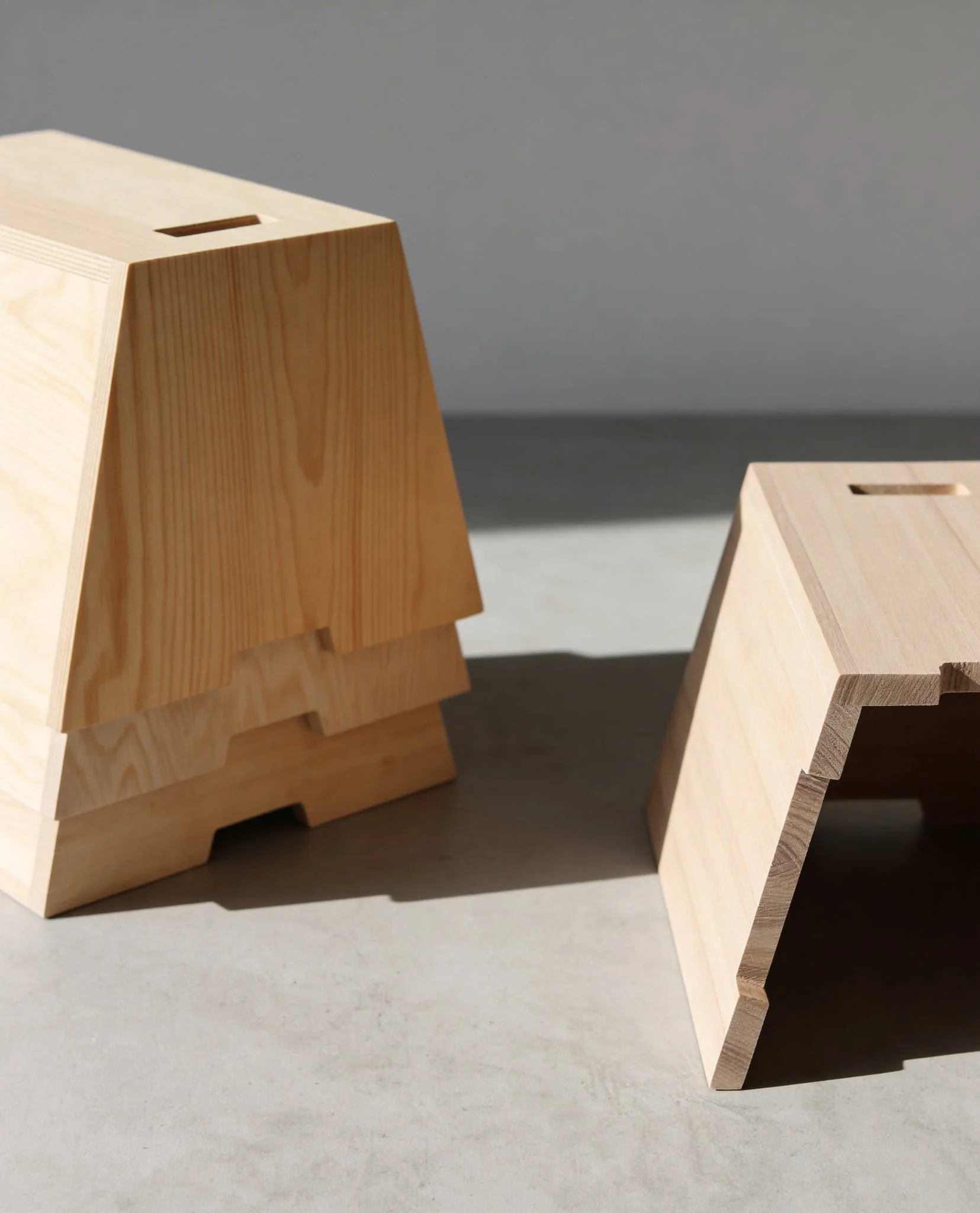 Stacked Arbetshäst stools in wood.