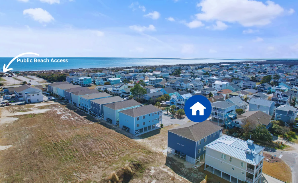 Aerial view of a coastal residential neighborhood with Sol Mar condo building  a blue home marker, and a labeled public beach access point to the beach and ocean in the background.