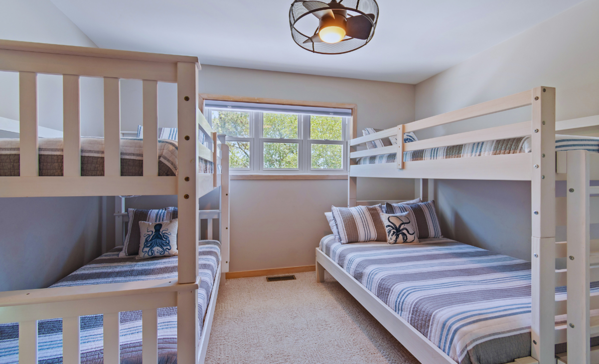 Bunk room at El Sol with two perpendicular bunk beds and octopus-themed pillows.