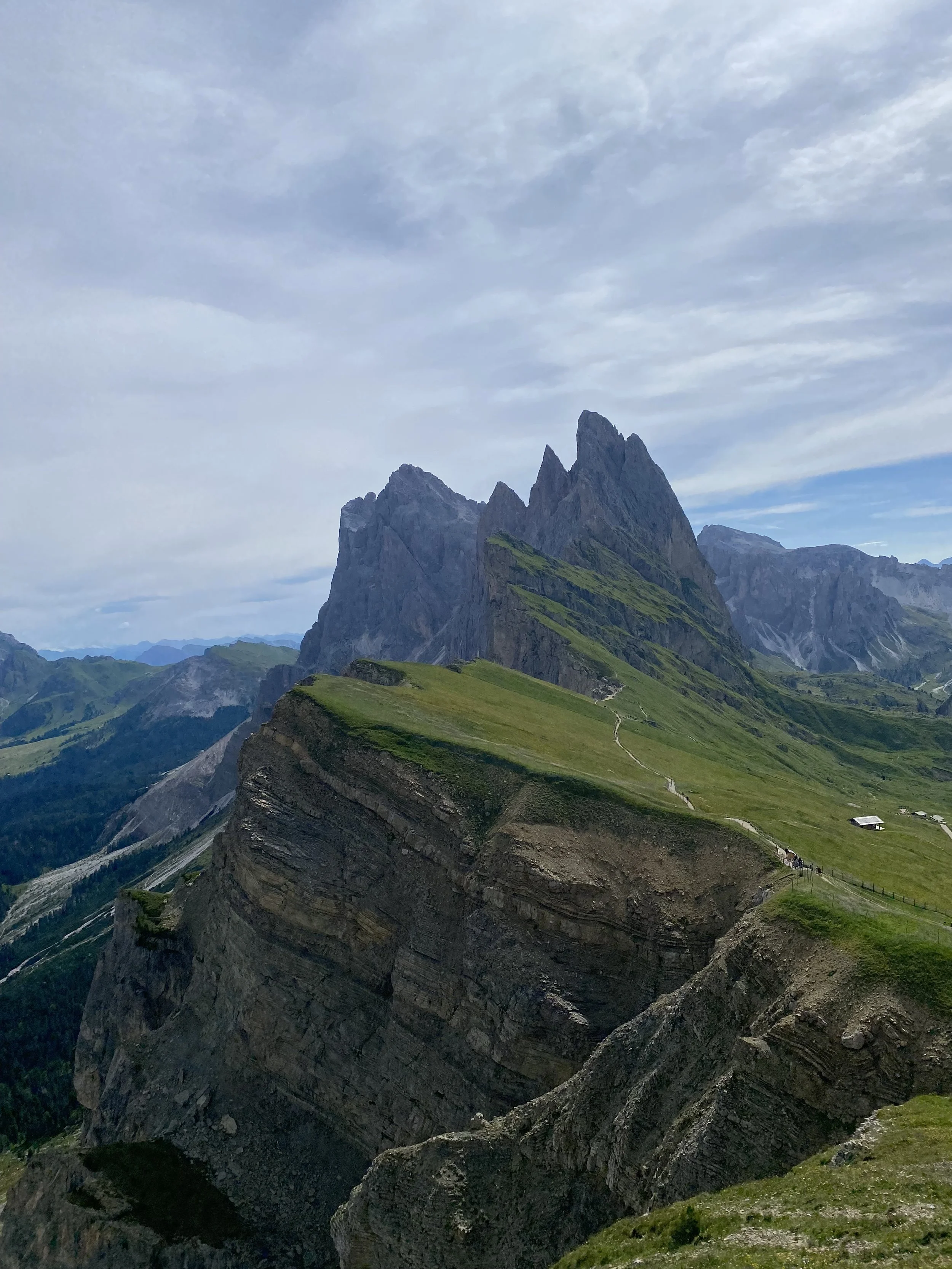 Seceda , rugged mountain peaks and green slopes in the Dolomites near Ortisei, Italy.