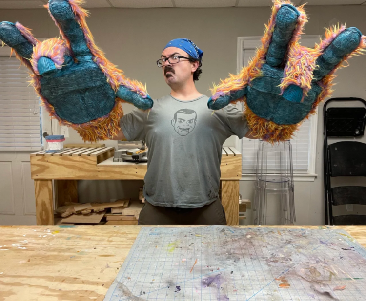 Sam carter professional puppet builder in shop with large puppet hands in Roswell GA