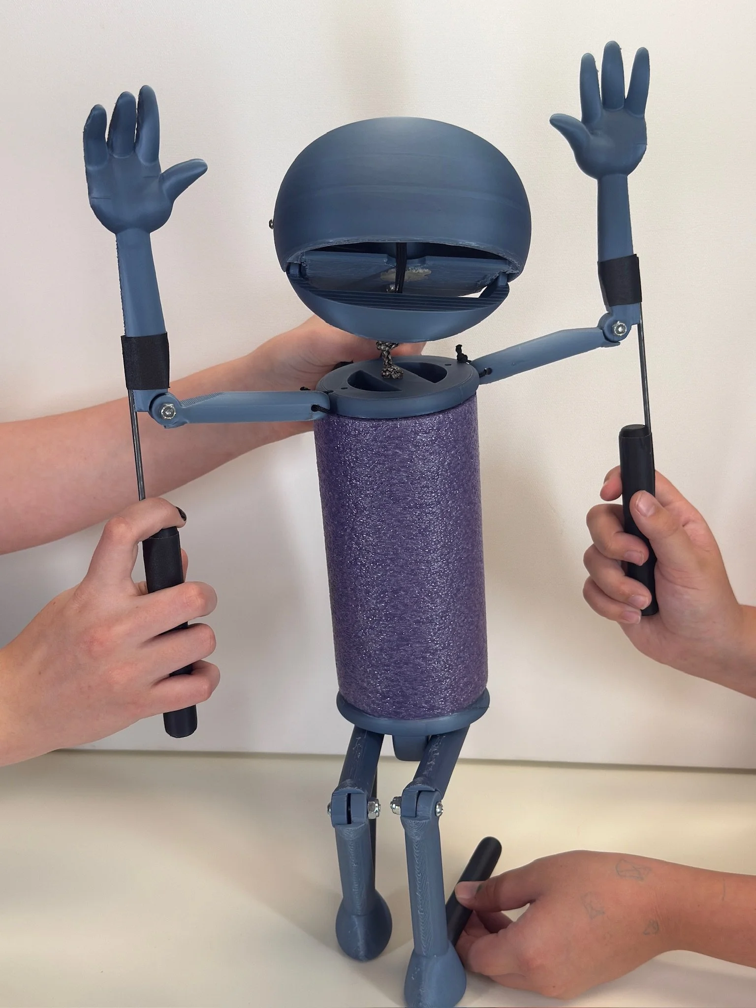 Boopos_blank_puppet_with hands in air and puppeteer hands
