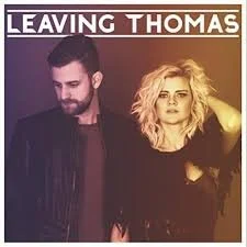 A man and a woman standing next to each other against a purple background, with the words 'Leaving Thomas' at the top.