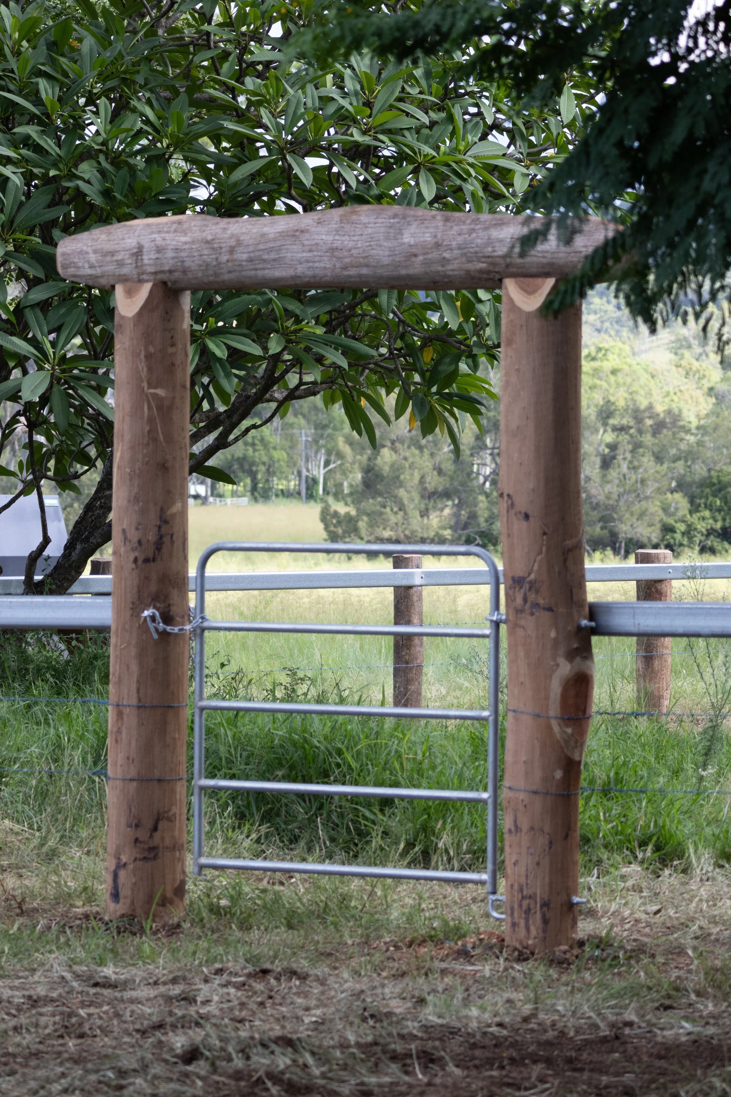 A wooden gate and fence installation on a rural property near Dalby