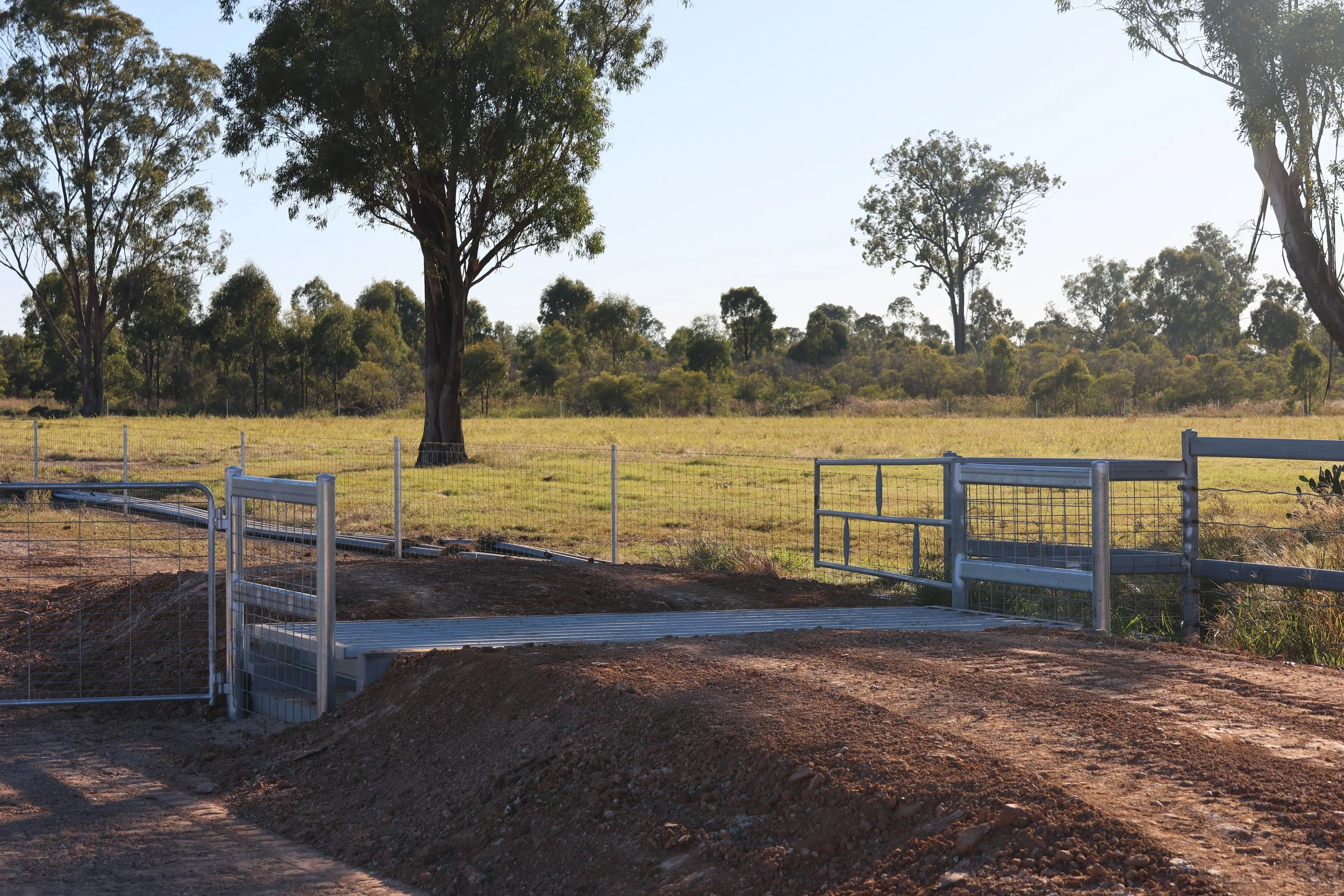 Rural driveway fence entrance by G8K Rural Co