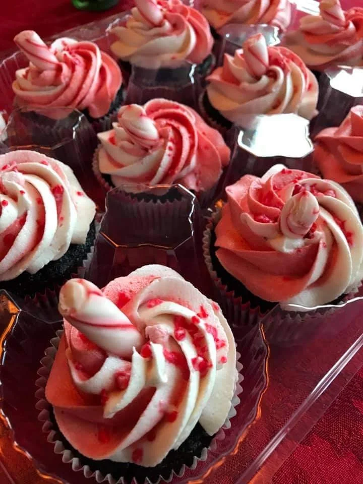 SweetSpiracy Peppermint and Chocolate cupcakes with pink and white swirled frosting, peppermint candy, and red sugar sprinkles.