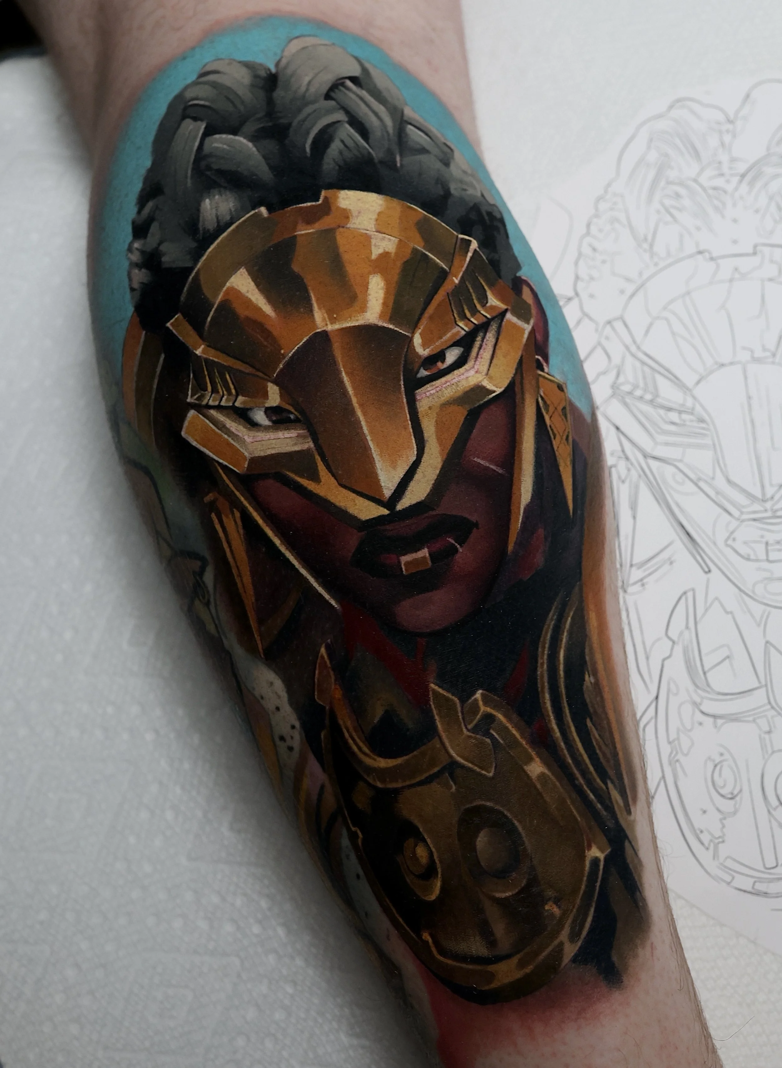 Colorful tattoo of Ambessa from Arcane wearing her iconic golden face mask.