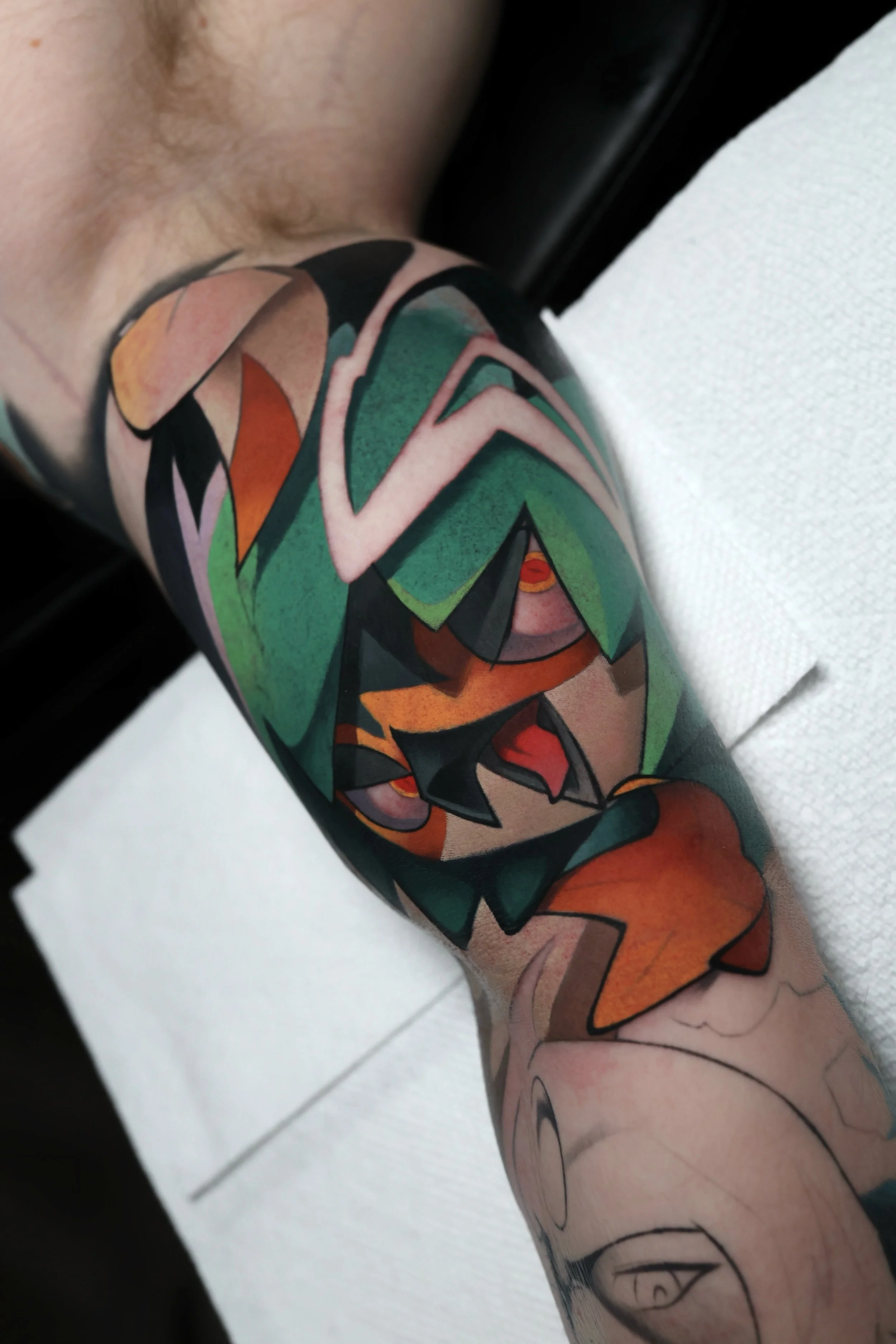 Colorful tattoo of the Pokemon Decidueye 