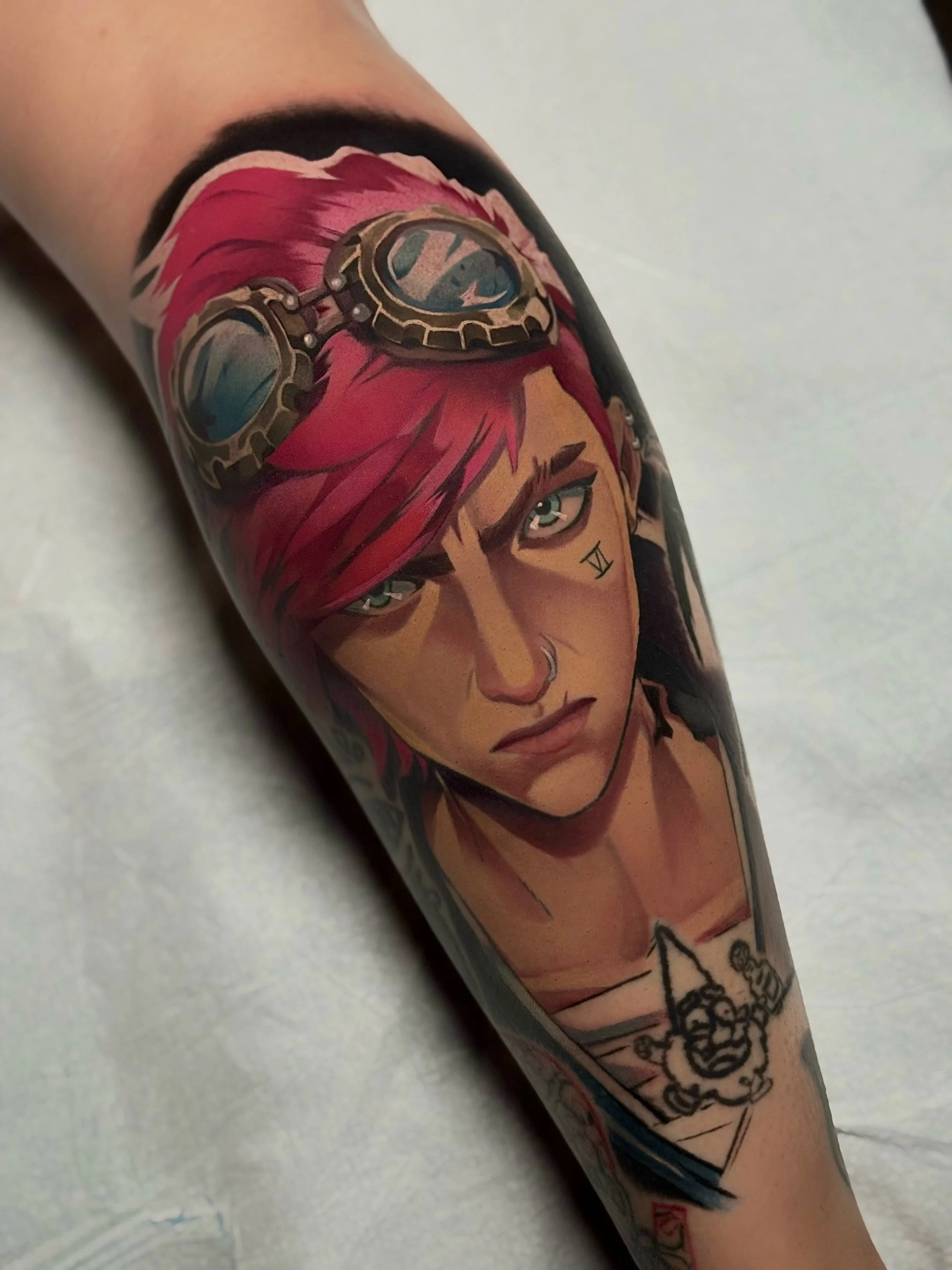 Colorful tattoo of Vi from the show Arcane with goggles on top of her head