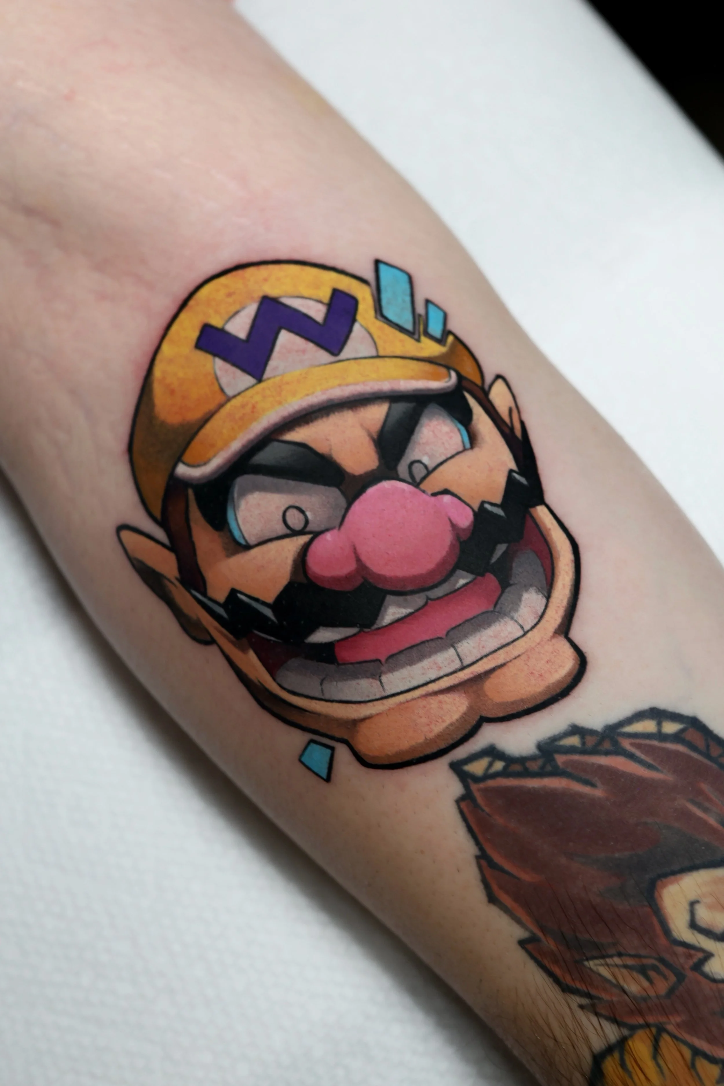 Colorful tattoo portrait of the nintendo character Wario 