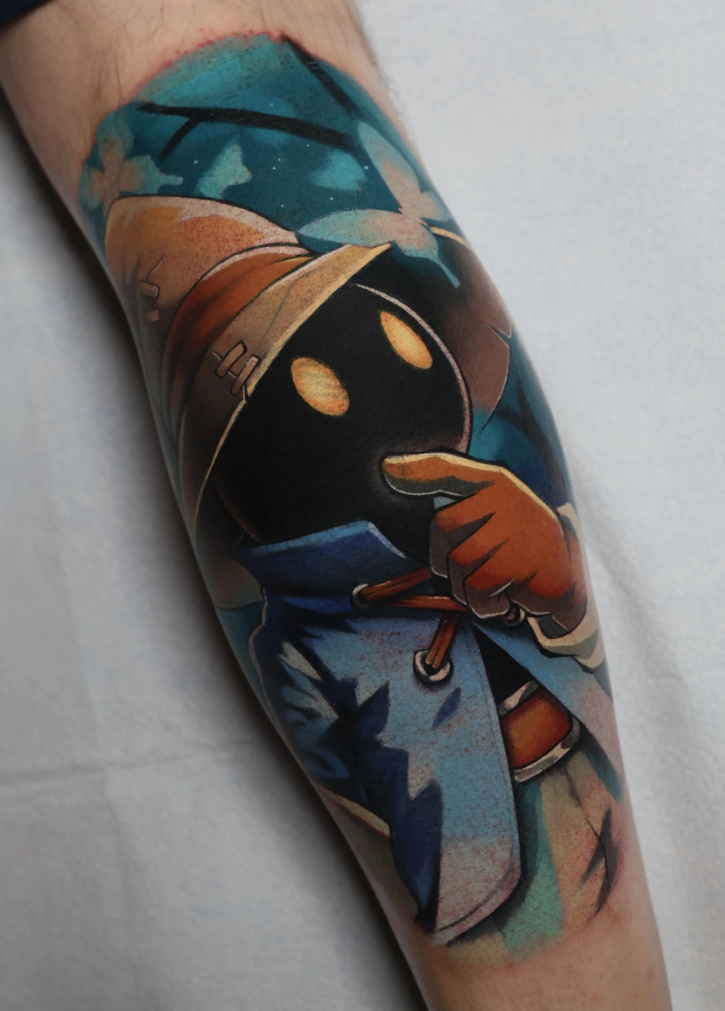 colorful tattoo of Vivi from Final Fantasy looking at a blue butterfly.