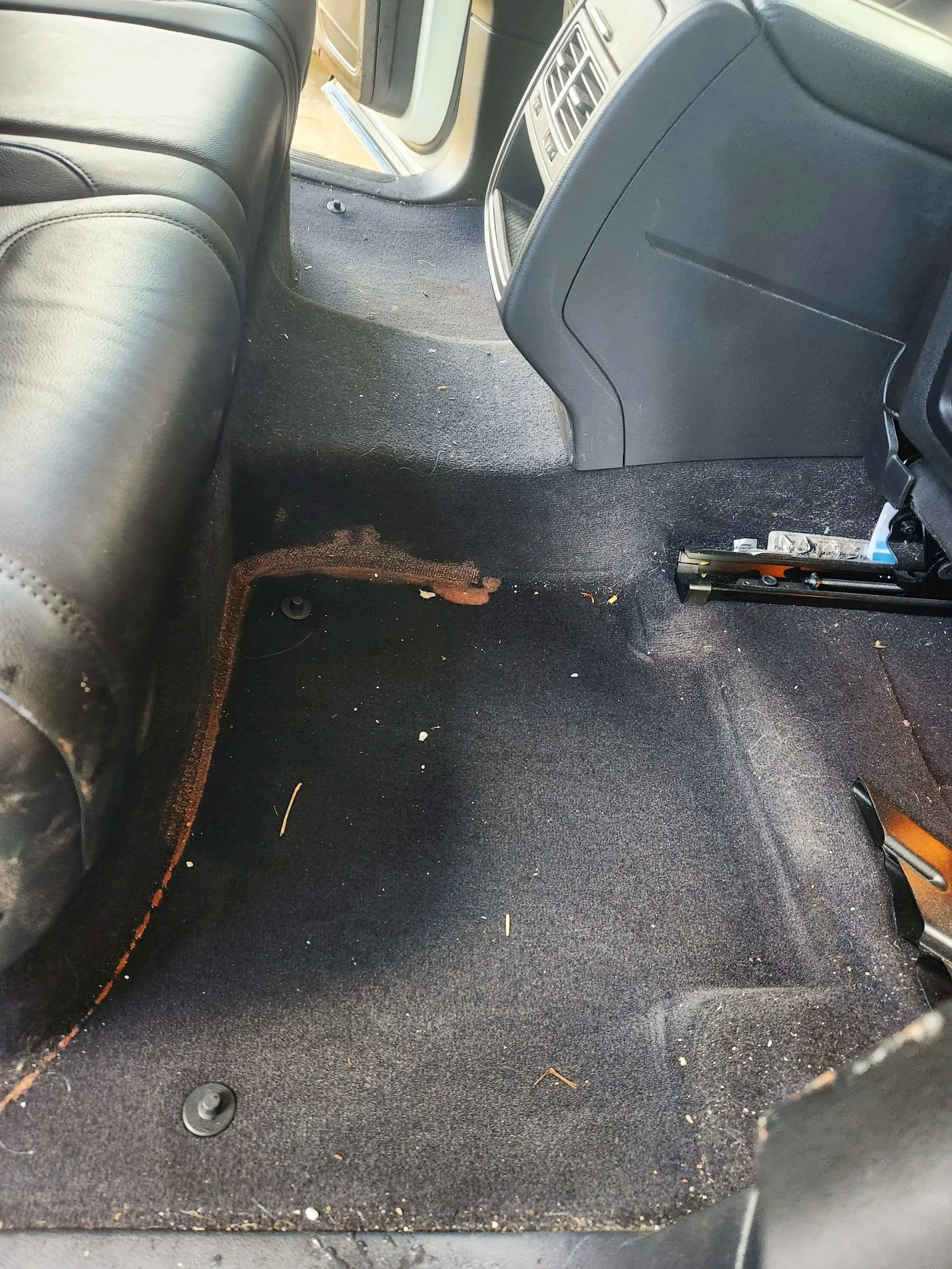Before: rear floor carpet stained and dirty.