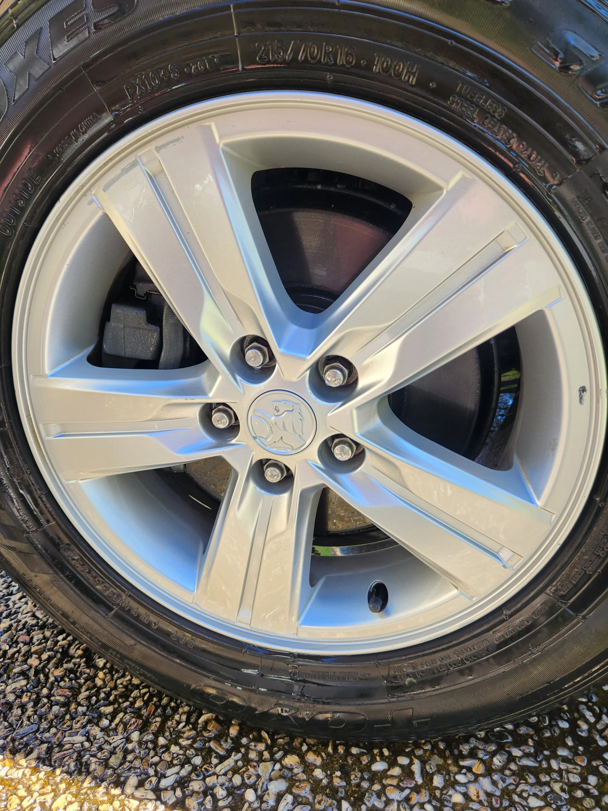 After: the same wheel cleaned with wheel cleaner, brake dust gone.