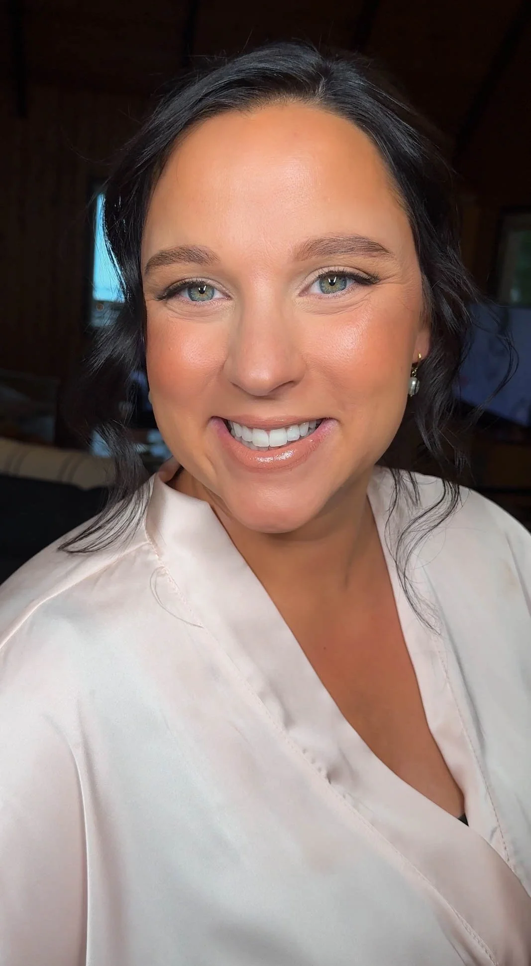 Glowing bridal makeup with defined eyes, radiant complexion and a soft glossy lip.