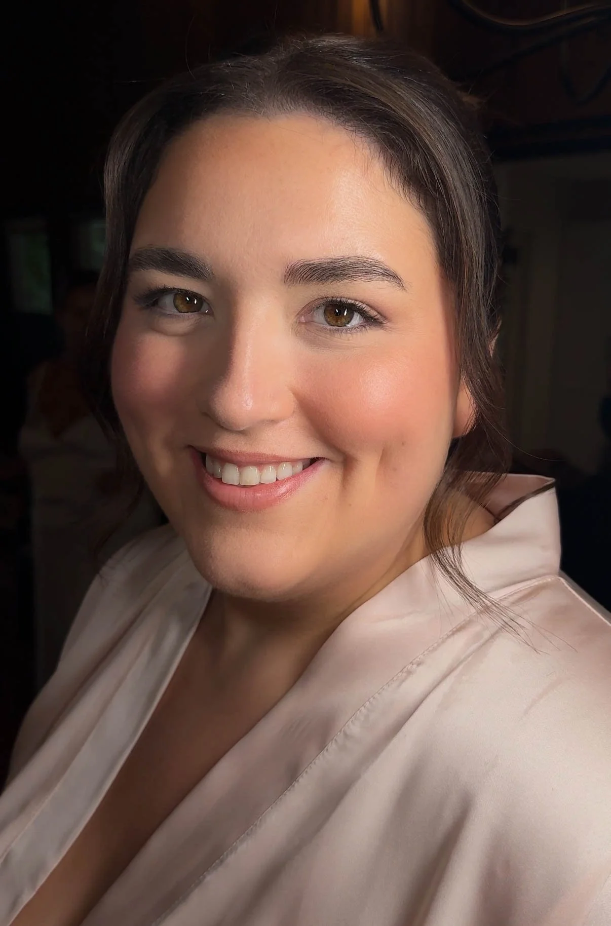 Soft natural makeup with radiant skin, rosy cheeks and subtle eye definition.