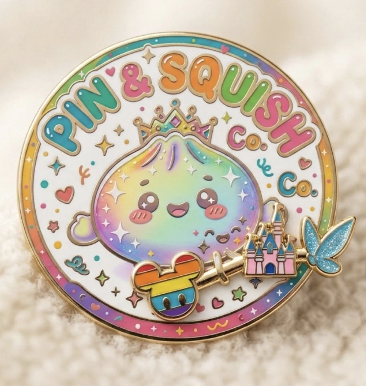 Colorful round pin with a rainbow-striped outline and a cute holographic unicorn face wearing a small crown. The pin has text reading 'Pony & Squash Co.' in bright colors, surrounded by tiny hearts, stars, and sparkles. Attached to the pin is a butte