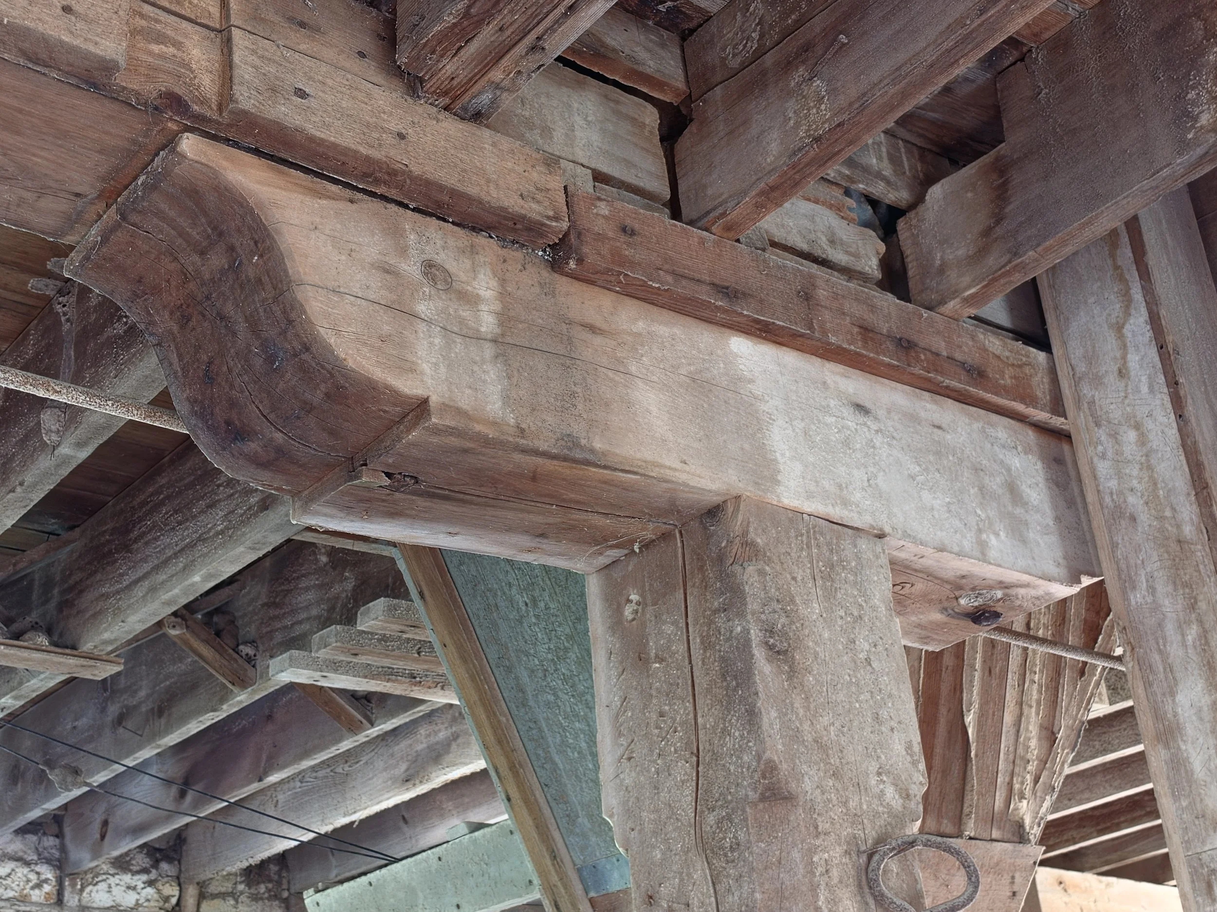 An ogee-profile wooden corbel inside Cedar Point Mill