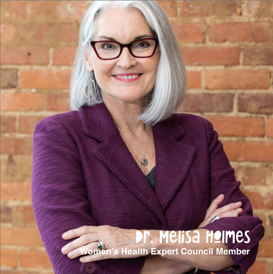 A woman with shoulder-length gray hair, wearing glasses, a purple blazer, and a silver necklace, standing in front of a brick wall. She is smiling and has her arms crossed. Text at the bottom identifies her as Dr. Melisa Holmes, Women's Health Expert Council Member.