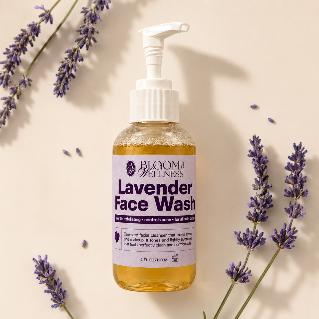 Bottle of Bloom Wellness Lavender Face Wash surrounded by sprigs of fresh lavender on a white background.