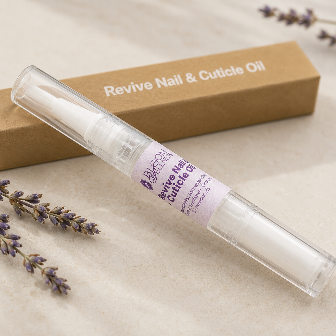 A tube of Revive Nail & Cuticle Oil with a lavender sprig beside it, placed on a light surface with a brown box in the background labeled 'Revive Nail & Cuticle Oil'.