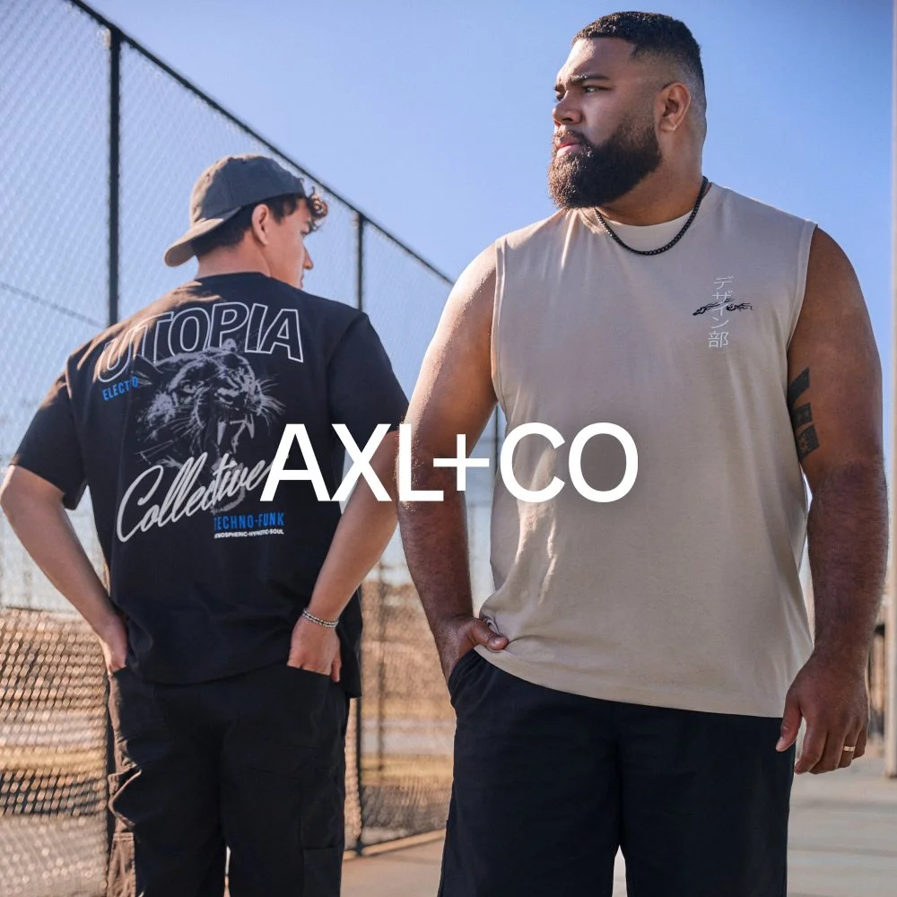 Two men standing outdoors by a chain-link fence, one with a beard wearing a sleeveless beige shirt and the other with a baseball cap and a black graphic T-shirt with a lion. The word 'AXL+CO' is written across the image.