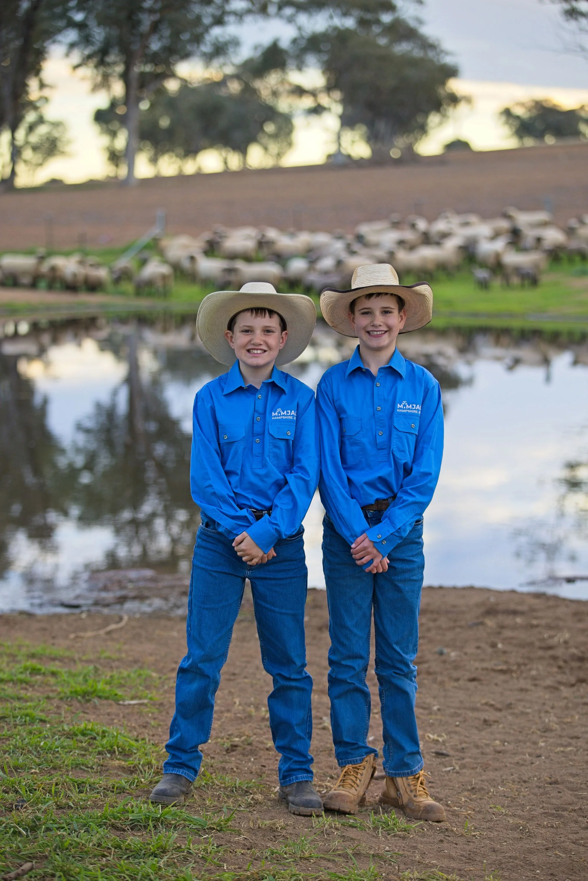 Mitchel and Jack Dickens founders of Mimjack Hampshire Down Stud, with sheep and water in the background