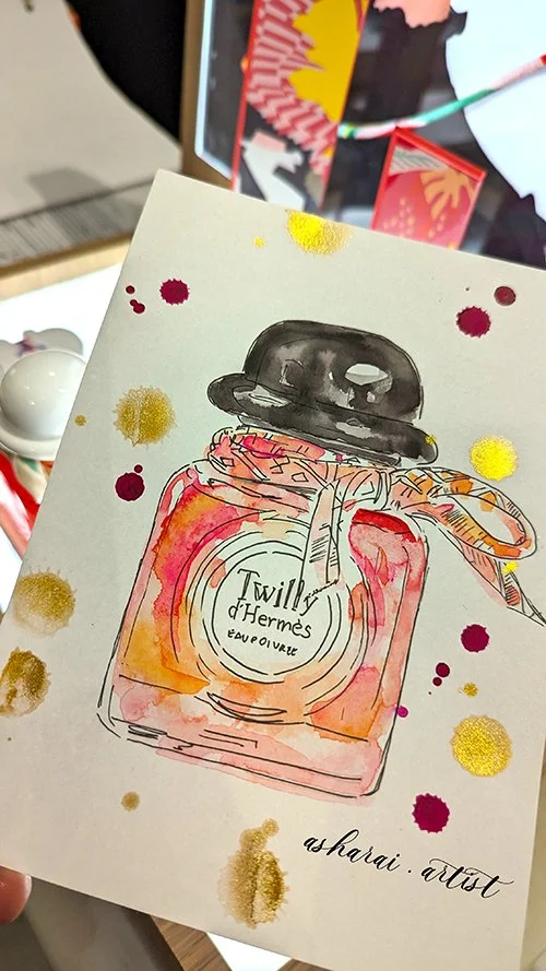 A watercolor illustration of a Twilly d'Hermès perfume bottle at Yorkdale Holt Renfrew for Beauty Edit Event