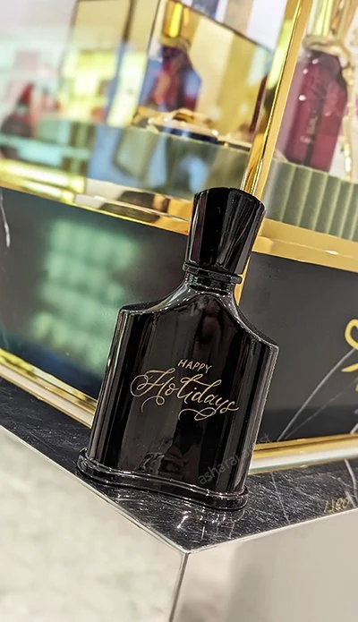 Custom engraving on Creed Absolu Aventus for Men at Holt Renfrew Yorkdale | Toronto Engraving Artist. Showcasing precision craftsmanship and luxury fragrance personalization. Live Artist
