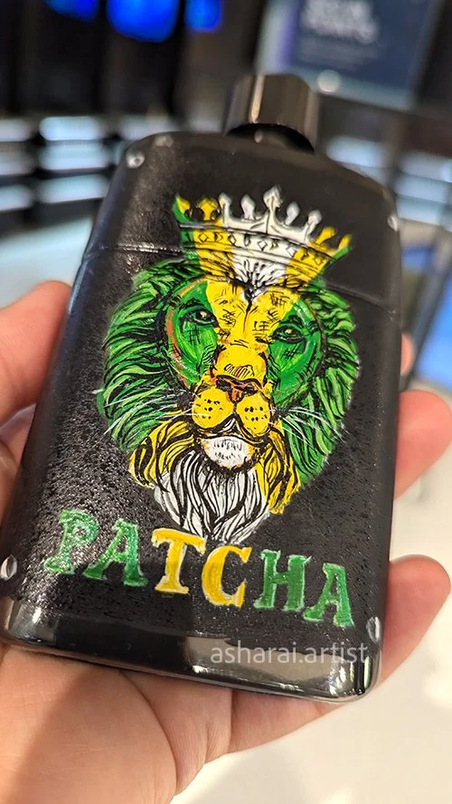Gucci Guilty Pour Homme Eau de Parfum bottle featuring a hand-painted lion in Jamaican flag colours and a personalized name, showcasing custom live bottle painting in Toronto.