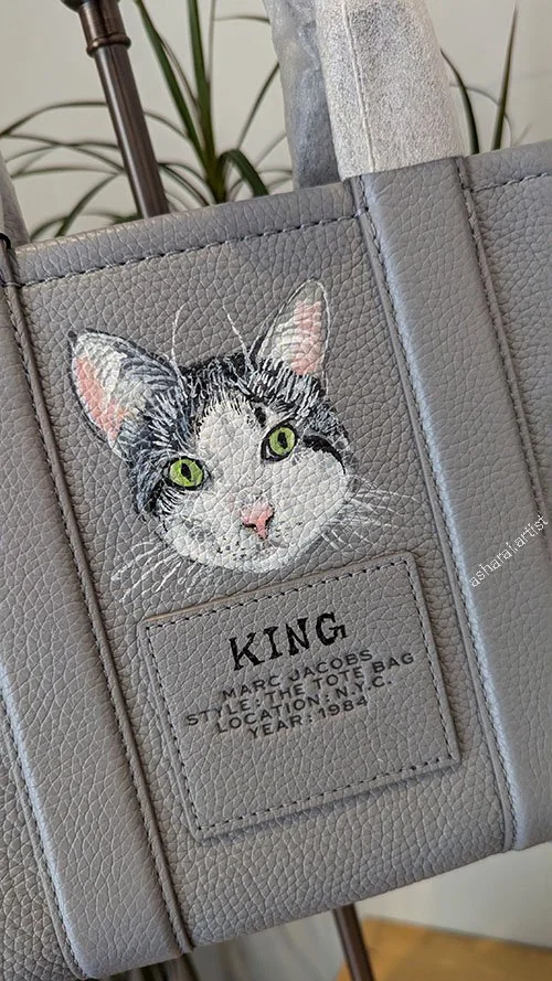 Marc Jacobs leather Grey tote bag  featuring a custom hand-painted pet portrait of a Cat named King, by AshaRai, luxury event artist, during a live in-store pet portrait event at Yorkdale.