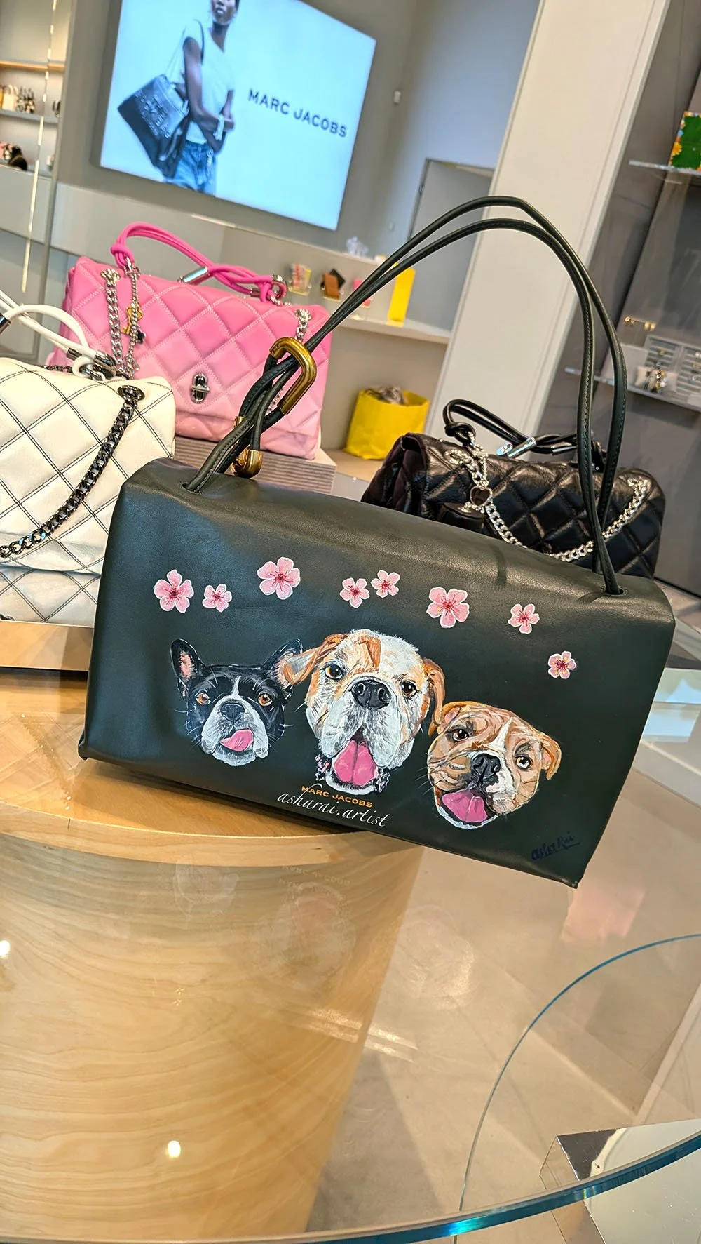 Marc Jacobs green leather bag featuring hand-painted portraits of three pets, created live by AshaRai, luxury event artist, during a pet portrait event at the Yorkdale boutique.
