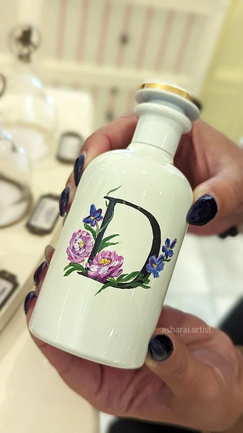 Gucci The Alchemist’s Garden Where My Heart Beats Eau de Parfum bottle featuring a hand-painted initial and floral design, created live at Holt Renfrew Yorkdale.