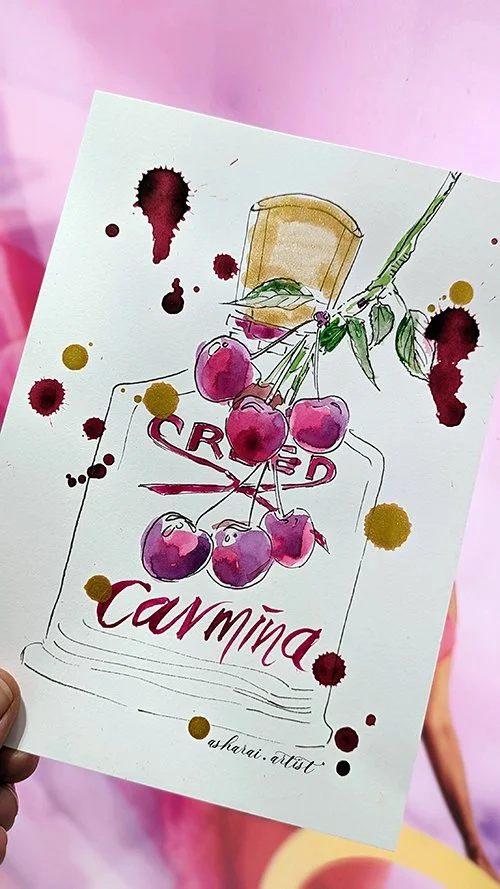 Hand-drawn watercolor illustration of a jar labeled "CROWD" with a bunch of cherries hanging from a branch on top of it, and the word "Carmine" written below. Paint splatters surround the drawing, set against a pink background.