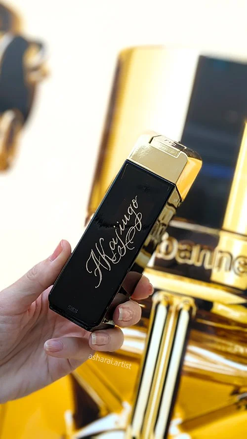 Hand-engraved Rabanne 1 Million perfume at the Square One pop-up event in Mississauga. Live engraving artist specializing in luxury fragrance personalization and bespoke engraving for luxury brands.