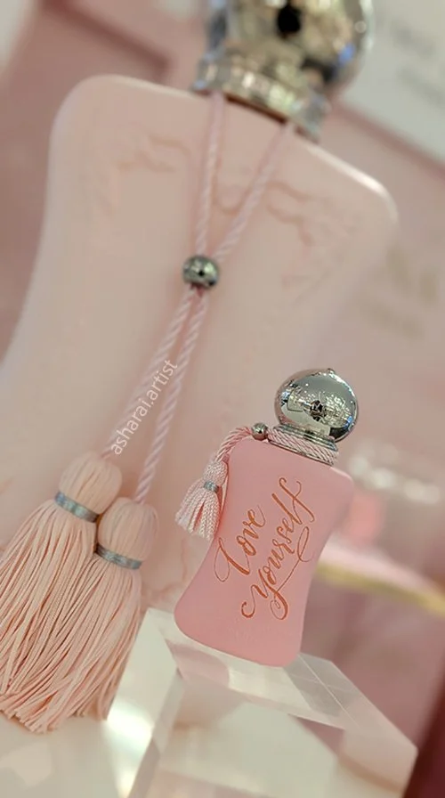 Hand engraving on the iconic pink Parfums de Marly Delina perfume bottle at Holt Renfrew.