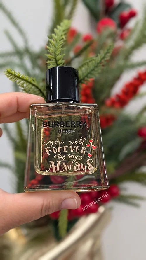 Burberry Hero perfume bottle personalized with the engraved message “Your Will FOREVER Be My ALWAYS” and hand painted red hearts in Sephora.