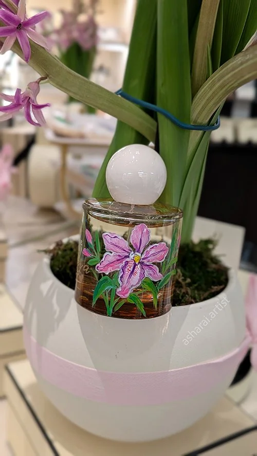 o Malone Beach Blossom bottle featuring a hand-painted purple calla lily, showcasing live bottle painting by a luxury event artist.